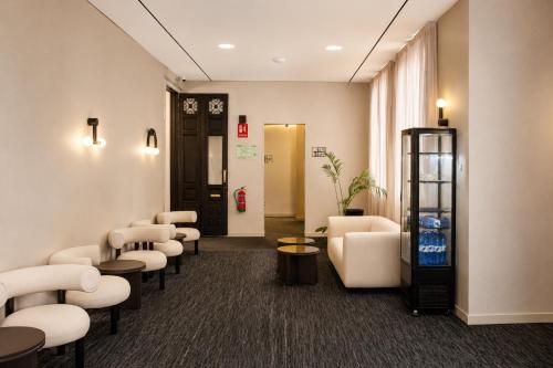 a waiting room with chairs and a coke machine at FORTINN Puerta del Sol in Madrid