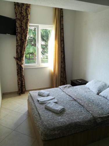 a bedroom with a bed with two towels on it at Art B in Ohrid