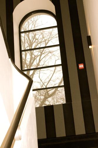 a stairway with a window in a building at The Hamptons Boutique Hotel in Ghent