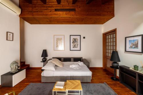 a bedroom with a bed and a wooden ceiling at Lodge Fiera Milano in Rho