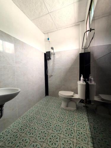 a bathroom with a toilet and a sink at Forge boutique in Chiang Mai