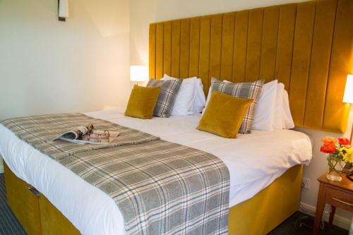 a hotel room with two beds and two lamps at Old Manor Hotel in Lundin Links