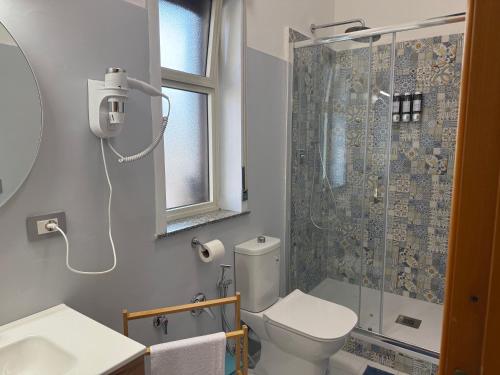 a bathroom with a toilet and a shower at Da Nonna Maria in Roccalumera