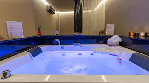 a jacuzzi tub in a room with a blue counter at Diwane Hotel & Spa Marrakech in Marrakesh