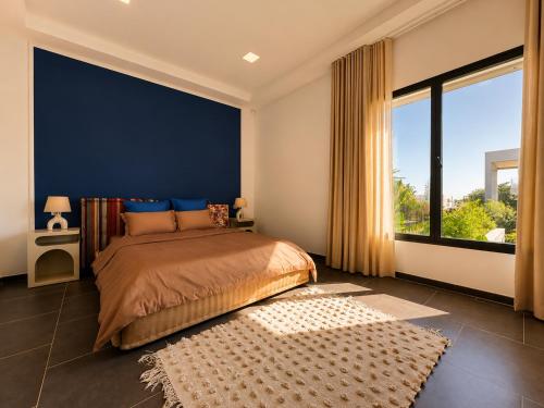 a bedroom with a large bed and a large window at Villa Solis Elegant Villa with Private Pool in La Marsa