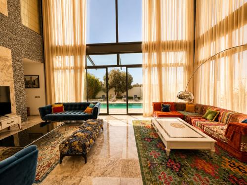 a living room with couches and a pool at Villa Solis Elegant Villa with Private Pool in La Marsa