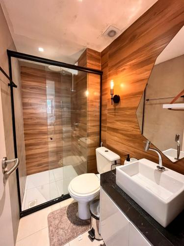 a bathroom with a toilet and a shower and a sink at Flat Manaira Apart Hotel 1605 in João Pessoa