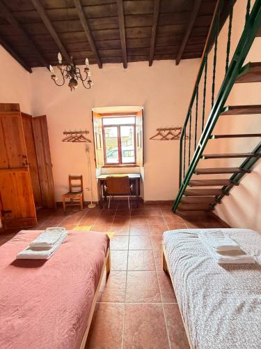 a room with two beds and a staircase at Solar Verbena in Vaiamonte