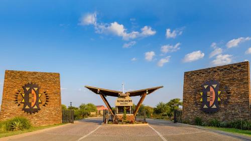 a gate to a building with a sign on it at The Kingdom Resort in Ledig