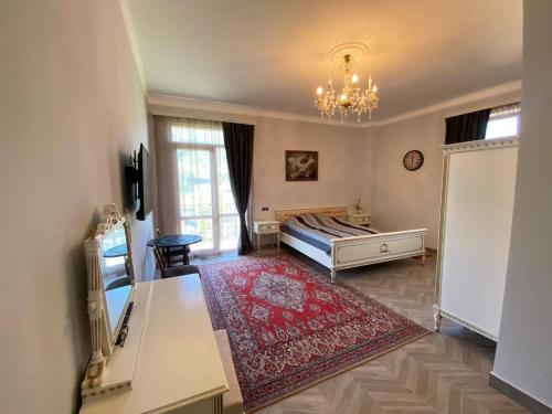 a large living room with a bed and a chandelier at Мгер Мелконян in Tsaghkadzor