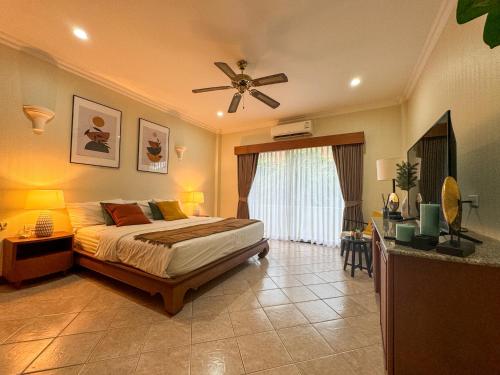a bedroom with a bed and a ceiling fan at View Talay Longstay Hotel & Suites in Jomtien Beach
