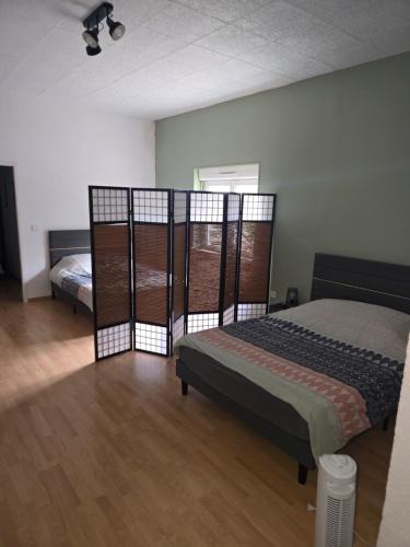 a bedroom with two beds in a room at Un petit coin de paradis in Gavarret