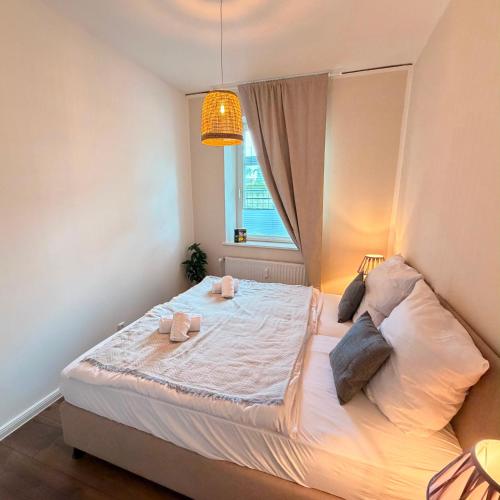 a bedroom with a large bed with a window at HYGGE HOMES Apartment - 'nordlys' in Lüneburg