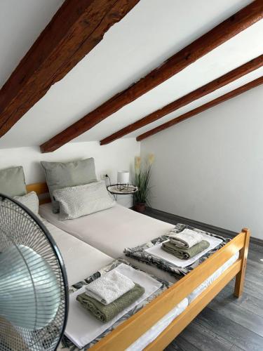 a bedroom with a large bed with a wooden frame at Moon Light-free parking in Rijeka