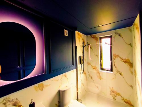 a bathroom with a sink and a mirror at Canal View Lodge & Spa - Entire 3 Bed Lodge in Longford