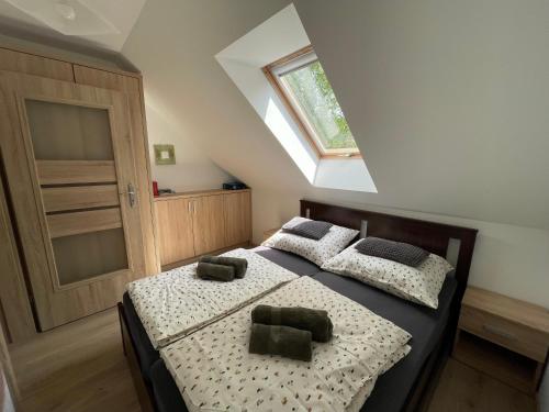 a bedroom with two beds and a window at Przylądek Werlas in Werlas