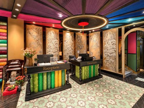 a lobby of a hotel with a reception desk at Loom Hotel Hanoi in Hanoi