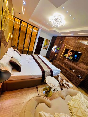 a hotel room with a bed and a tv at Armacruz Luxury Hotel And Apartment in Warri Airport