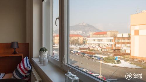 a window with a view of a city street at Černy Andēl in Most