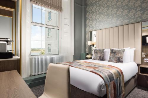 a hotel room with a bed and a window at The Grand Hotel in Malahide