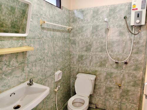 a bathroom with a shower and a toilet and a sink at S2S Queen Trang Hotel in Trang