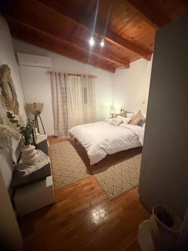 a bedroom with a white bed and a window at All seasons Mountain escape in Vília