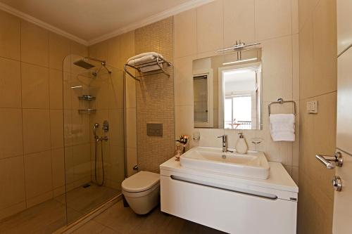 a bathroom with a sink and a toilet and a shower at Aktur Residence in Bitez