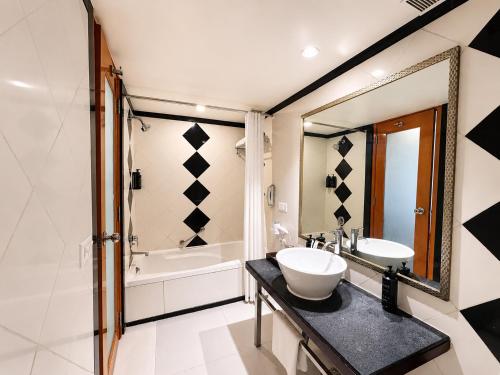 a bathroom with a sink and a tub at Ramada By Wyndham Jaipur in Jaipur