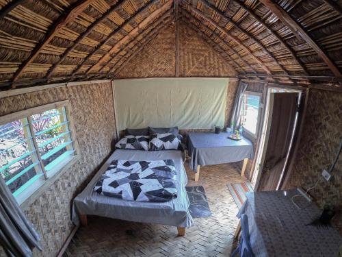 an overhead view of a room with two beds and a table at Asaro Mudman Cultural Lodge in Goroka