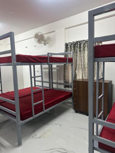 a room with two bunk beds and a window at DM Bliss in Chikmagalūr