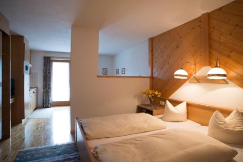 a bedroom with two beds in a room at Edelweiss 209 - Typ B in Fontanella