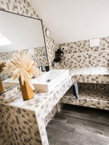 a bathroom with a sink and a mirror at Apartment Loft Pejić - open space loft studio near Bovec, Soča Valley in Bovec