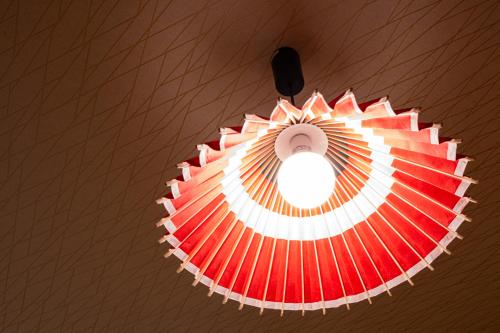 a ceiling light with a red and white umbrella at Ciel東池袋 in Tokyo