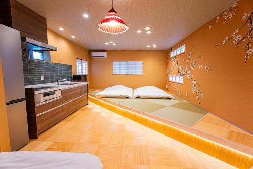 a kitchen with two beds in the middle of a room at Ciel東池袋 in Tokyo