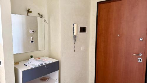a room with a door and a table and a mirror at Casa Ada in Termoli