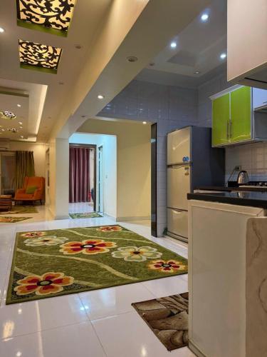 a kitchen with a kitchen rug with flowers on the floor at See side view city square 42 in Alexandria