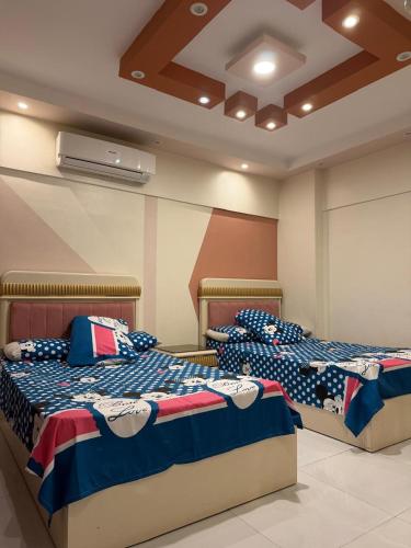 two beds sitting next to each other in a room at See side view city square 42 in Alexandria