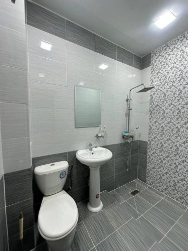 a bathroom with a toilet and a sink at Ситора in Dushanbe