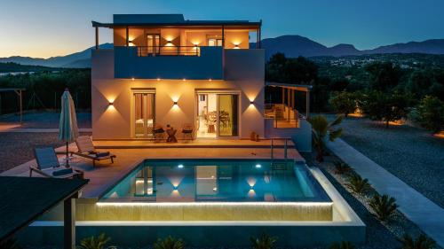 a house with a swimming pool in front of it at Paradise Garden Villa in Moírai