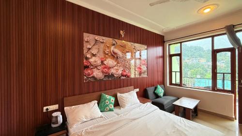 a bedroom with a bed and a painting on the wall at Backpacker Inn Mcleod in Dharmsāla
