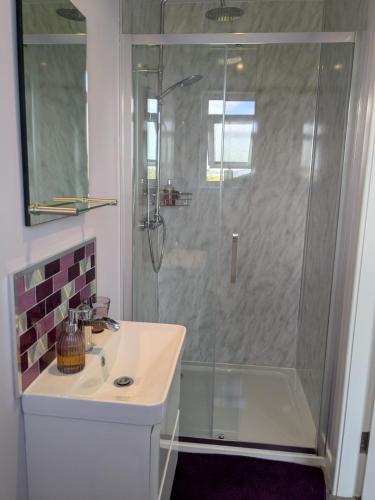 a bathroom with a shower and a sink at An Airigh Bed & Breakfast in Kirkhill