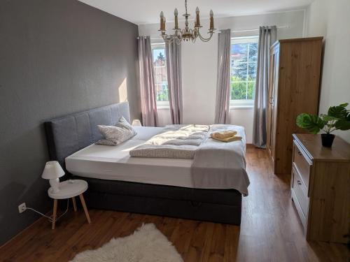 a bedroom with a large bed and a window at Lüsser Landsitz in Bad Belzig