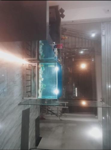 a glass table in front of a room with at aadi shakti palace in Faizābād