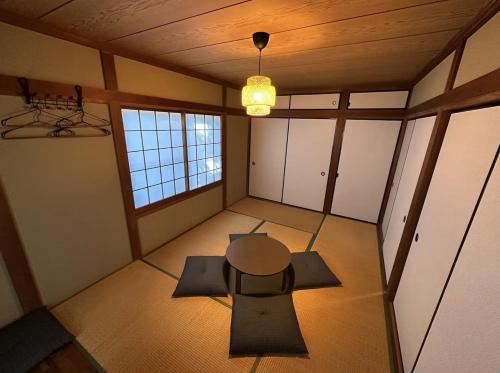 an empty room with a table and chairs in it at Shirako House in Shirako