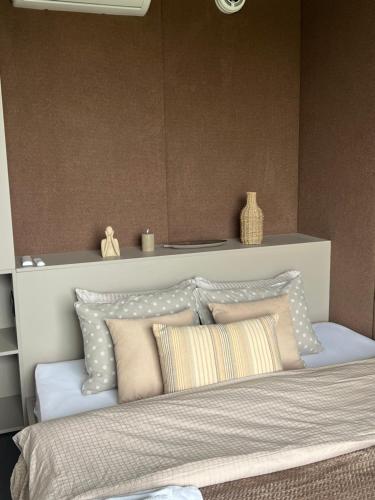 a bedroom with a bed with pillows on it at Neboskhyl House in Khorosno