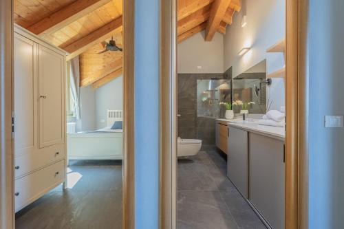 a bathroom with a sink and a toilet in a room at Veloccino del Lago in Perledo