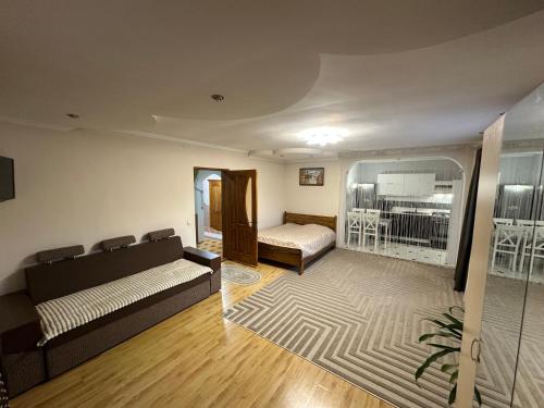 a living room with a couch and a bed at Fetal Hut - Плідна Хата in Verkhovyna