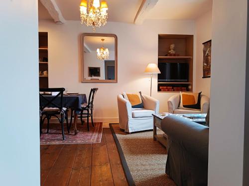 a living room with a couch and a table at Maison Nº 20 in Eymet