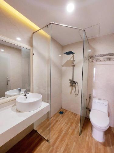 a bathroom with a sink and a toilet and a shower at Sencoco Hotel in Hà Quảng (4)