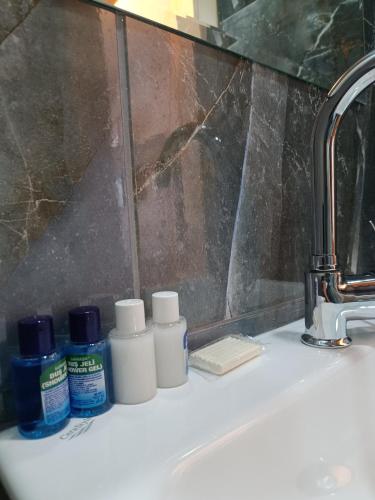a bathroom sink with toiletries sitting on it at Pamukkale Cleopatra in Pamukkale